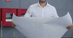 Entrepreneur holds blueprint of building apartment. Remote worker manager waits for meetup with colleagues from estate agency