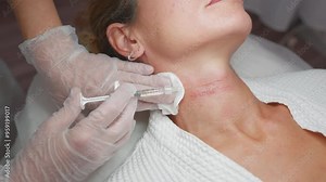 Doctor Cosmetologist Makes Rejuvenating Injections Procedure for Tightening and Smoothing Wrinkles on Skin Neck of a Beautiful Woman in Beauty Salon. Injection Contour Plastic Surgery.