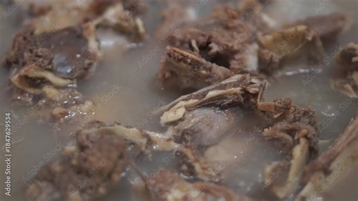 Boiling beef meat for food preparation, commonly used as a base ingredient in Asian and local dishes.