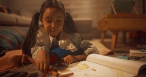 clip-1108362993-evening-portrait-cute-little-girl-drawing-while