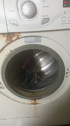 Close-Up of a Damaged Front-Loading Washing Machine