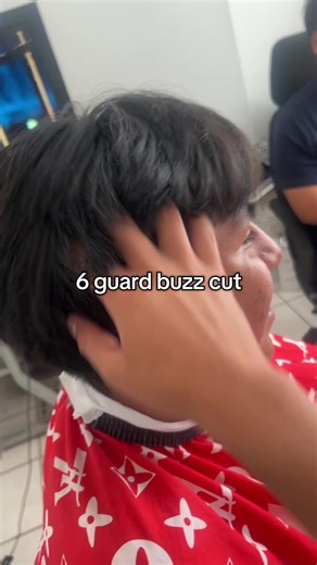 Barber Expertly Styles a 6 Guard Buzz Cut
