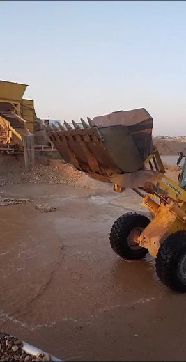 Front Loader at Work: Dumping Water and Gravel