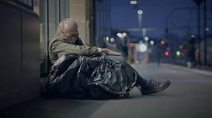 Elderly Homeless Man Suffering from Poverty Looking for Help at Train Station