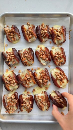 Baked Dates - a fun appetizer for Thanksgiving that’s so easy to pull together. Assemble and pop in the oven 5 minutes before guests arrive! INGREDIENTS 16 Medjool dates, pitted 1/2 (8-ounce) block sharp cheddar cheese, sliced into 16 pieces 1/3 cup chopped pecans (16 teaspoons) INSTRUCTIONS 1. Preheat the oven to 350°F and line a small baking sheet with parchment paper. 2. Place the pitted dates on the prepared baking sheet spread out into 4 rows or 4. Add the sliced cheese inside each pitted d