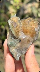 This stunning Golden Rutile Quartz with Chlorite inclusions comes straight from the mineral-rich lands of Himachal Pradesh, India! ✨ The golden rutile needles form intricate, hair-like patterns inside the quartz, giving it a mesmerizing glow when hit by sunlight. These needle-like inclusions are actually titanium dioxide, which forms in a lattice-like structure within the quartz over millions of years. The presence of Chlorite adds another fascinating dimension to this specimen, with its soft gr