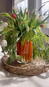 Carrot and Tulip Centerpiece 🥕is truly a garden-inspired arrangement! Elevate your Easter table with a sophisticated floral centerpiece that seamlessly blends the beauty of nature indoors! Delight your guests with vibrant tulips and playful carrot stems in a clear vase—a whimsical and elegant touch that captures the spirit of the Spring season. Adding a penny to tulips is a folk gardening trick believed to keep the flowers perky. The copper in the penny is thought to act as a fungicide, prevent