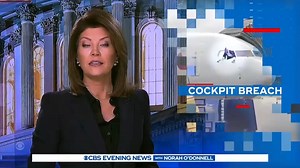 An American Airlines passenger is now in police custody after storming the plane’s cockpit, damaging the controls and trying to jump out the window. Passengers and the crew had to switch planes and the airline is now pressing criminal charges. | CBS Evening News