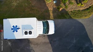 overhead view ambulance backing up with driver stepping out and walking to the back