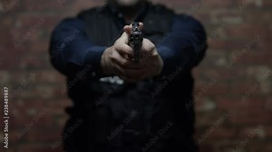 A police officer demonstrates the use of his weapon