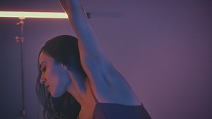 Young ballerina dancing artistically in a dark place - Free Stock Video