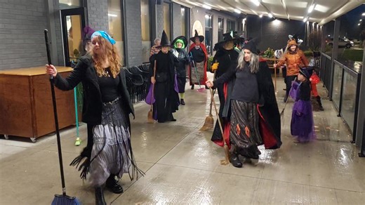 A spell of heavy rain didn’t stop the witches from taking over East City tonight. Dressed in pointed hats, capes, and Halloween colours, the group gathered outside the Canadian Family Health building on Rogers Street, where they kicked off their lively flash mob before making their way through the rain to The Rail Yard Restaurant. Once there, the witches continued to dance and celebrate under a canopy outside the restaurant, keeping the fun going despite the weather. The witches’ flash mob has b