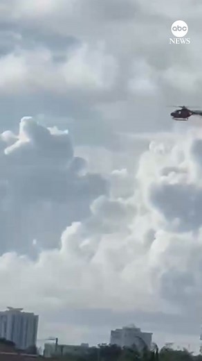 Dramatic new video shows the moment a helicopter that caught fire plummets from the sky. Two people were injured in the crash and taken to the hospital, the Broward Sheriff’s Office said. #news #helicoptercrash #florida