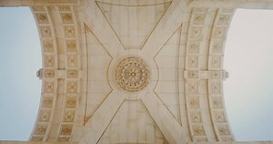 Download The ceiling of the marble triumphal arch in the classical style. Bottom-up view inside the arch