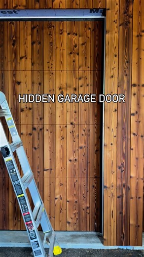 NS Builders - Luxury Custom Home Builder on Instagram: "6 Cars, 0 Compromise Three spaces under the bridge, three inside the garage—all protected from the elements. The garage doors are high-quality units from @designergaragedoors, clad in @thermoryusa spruce with a single coat of Cutek oil. Installed full height, then track-sawn to create a perfect 3/32” gap between each panel. Over time, the finish will silver out beautifully. Carpentry by @site_elements By NS Builders × @of_possible"