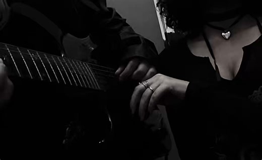Playing guitar with her nails