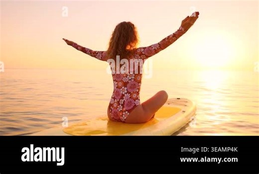 Happy young woman practicing yoga on stand up paddle board by the sea during summer vacation. Beautiful girl flat water paddling against sea and sky background. Healthy lifestyle concept. Slow motion Stock Video Footage - Alamy