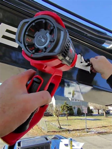 removal of lettering in the shade on a cold day.