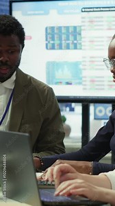 Vertical Video Team of workers presenting infographics and sales numbers on an interactive board, boardroom activity. Diverse group of professionals engages in a project management meeting for growth