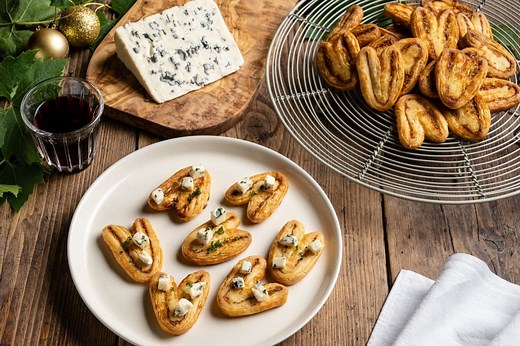 Delicately crisp palmier biscuits are often served as a sweet treat, however here Raymond spreads Saint Agur blue cheese between the layers of pastry to create a savoury festive version. See the full recipe here: https://www.greatbritishchefs.com/recipes/saint-agur-palmiers-recipe | Great British Chefs