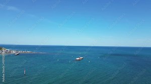 Aerial footage of the sunken HMVS Cerberus along Half Moon Bay beach, with parts of the historic ship poking out of the turquoise waters, creating a striking contrast against the sandy shoreline.