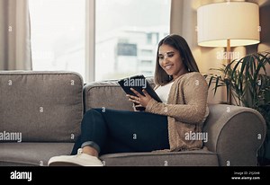 Couch, woman and relax with tablet for streaming, online video and social media with smile at home. House, female person and comfortable with digital Stock Photo - Alamy