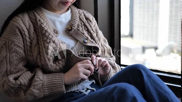 A Japanese woman taking off her clothes.