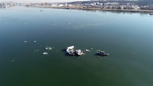 Drone video shows plane, helicopter submerged in Potomac
