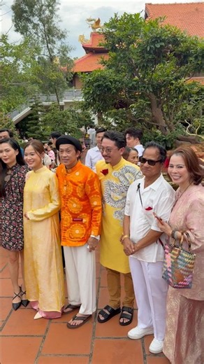 Comedian Hoai Linh takes a souvenir photo with famous singer Che Linh and actor Hua Minh Dat with...
