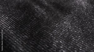 Black denim, jean fabric cloth background. Fashion, modern dress material.