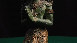 Angel Buddha kneeling in prayer rotating turntable dark background spiritual art