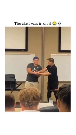 guffvibes on Instagram: "This video captures a lighthearted and funny moment in a college classroom. Here is a breakdown of what happens: The "Prank" Magic Trick The teacher is performing a magic trick for a student volunteer at the front of the class. He uses a small red ball, pretending to make it disappear and reappear between their hands. The "trick" is actually a coordinated prank by the entire class: The Teacher's Role: He performs basic sleight of hand, but the real magic is his acting. T