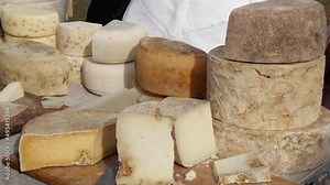 Artisanal farmstead cheese, made traditionally with milk from the producer's own herds of cows, sheep, and goats. Local produce market in an outdoor space