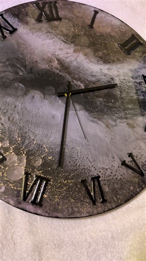 ✨ Hand-Crafted Resin Wall Clock – A Statement Piece of Functional Art ✨ Turn time-keeping into a luxury experience with this stunning, hand-poured resin wall clock. Each piece is uniquely crafted, meaning no two clocks will ever be the same — making yours a true one-of-a-kind work of art. Featuring a mesmerising swirl of deep greys, silvers, and metallic tones, the surface of the clock captures light beautifully, giving it a cosmic, marble-like finish. The raised Roman numerals and sleek black h