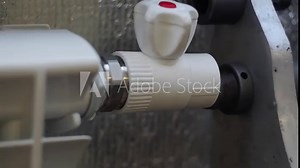 A worker welds polypropylene pipes.Welding of polypropylene pipes with a special welding machine. Plumbing works.