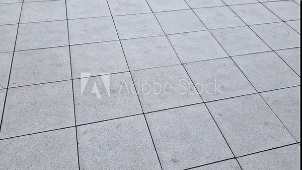 chess board made of small marble cubes. the gray and white mosaic in the square is a classic visual cliché. pavers work advertising spot. surface detail