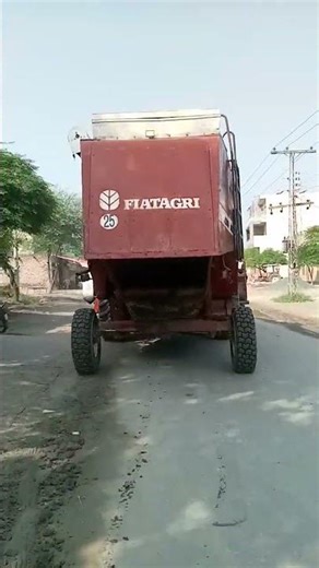 "Combine Harvester on the Way to Harvest Rice Crop"