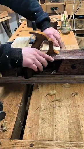 Smoothing wooden surface using hand plane tool