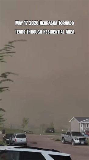 May 17 2026 Nebraska Tornado Tears Through Residential Area Breaking footage from May 17 2026 shows a powerful tornado moving directly through a residential area in Nebraska as intense winds rip apart homes and send debris flying across the neighborhood Residents watched in shock as the massive storm carved a path of destruction during a dangerous severe weather outbreak. #Tornado #Nebraska #Storm #ExtremeWeather #severeweather