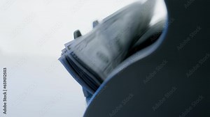 Money counting machine. Dollar banknotes on a bill counter. Modern bank equipment is processing usa currency. Automatic operations of cash. Banking or commercial activity and investment concept