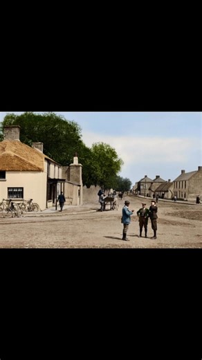 Tallaght Village in Dublin 1920s Ireland. The scene shows the village before its significant suburban development, which began in the 1970s. Tallaght was a small village until the 1960s, with a population of about 2,500. It has a history as a monastic settlement dating back to at least the 8th century. The village is located in the foothills of the Dublin Mountains and is traversed by the River Dodder. The area has been designated as both an Area of Archaeological Potential and an Architectural 