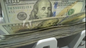 Money counting. Close up currency counting machine counting dollar bills. Machine counter calculates 100 dollars banknotes in slow motion. Closeup currency count machine counting dollar banknotes.