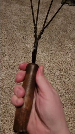Antique metal rug beater with wooden handle