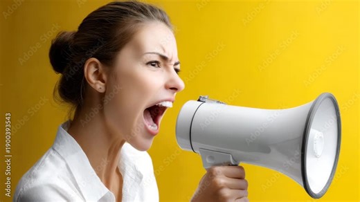 Young woman shouting into megaphone against yellow background conveying urgency and communication energy young woman shouting into megaphone with intense expression against yellow background