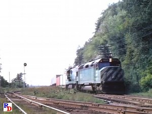A Burlington Northern freight, with nice bright green and yellow caboose bring up the rear, in the early 70's. Caught while waiting on an Amtrak! :-) From Early Amtrak across Wisconsin: https://rfd.video/EarlyAmtrak | Railfan Depot