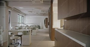 Elegant and modern nail salon interior featuring neat workstations with mirrors and stylish furniture. Bright lighting and spacious layout provide a welcoming atmosphere. Modern Nail Salon Interior