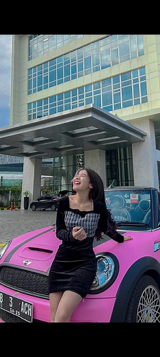 Stylish Poses with a Pink Car in Modern Setting