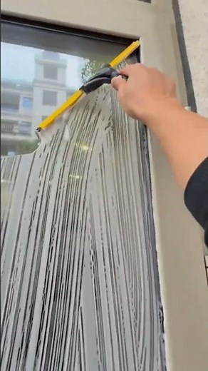 Professional Cleaner Washing Window Glass Surface Using Squeegee Tool