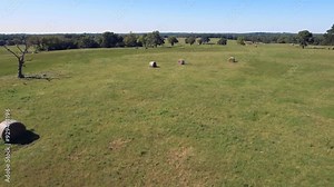 Drone footage of hay bales in a rural Oklahoma pasture
