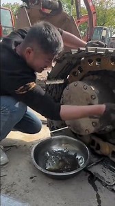 the process of removing a bolt for changing the oil on a heavy equipment vehicle #automobile